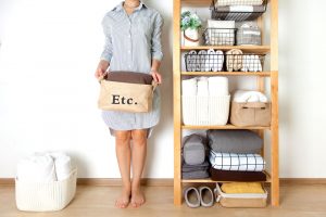 Spring,Cleaning,Of,Closet.,Vertical,Tidying,Up,Storage.,Neatly,Folded woman beside home organization